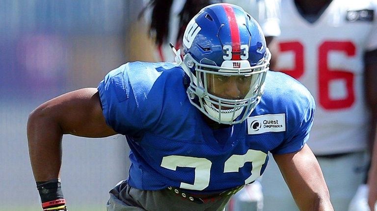 Giants defensive back Andrew Adams runs a defensive