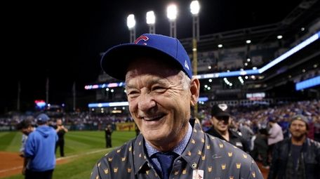 Actor Bill Murray reacts on the field after