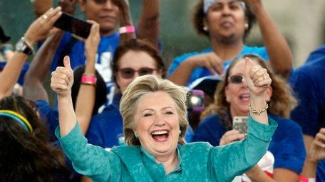 Democratic presidential candidate Hillary Clinton gives supporters a