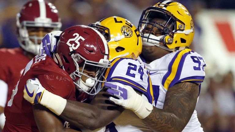 Alabama running back Joshua Jacobs (25) is wrapped