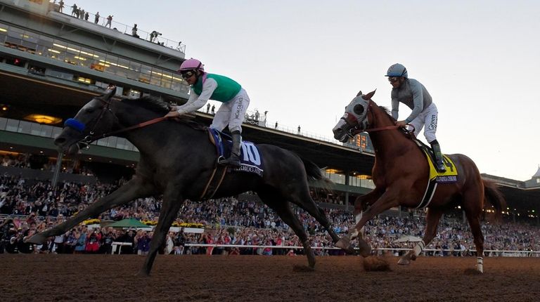 Arrogate with jockey Mike Smith, left, wins the
