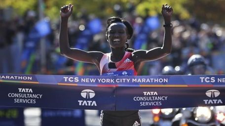 Mary Keitany of Kenya crosses the finish line