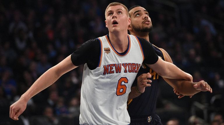 New York Knicks forward Kristaps Porzingis boxes out