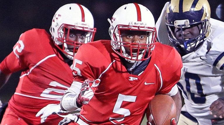 Freeport QB Rashad Tucker runs during the Nassau