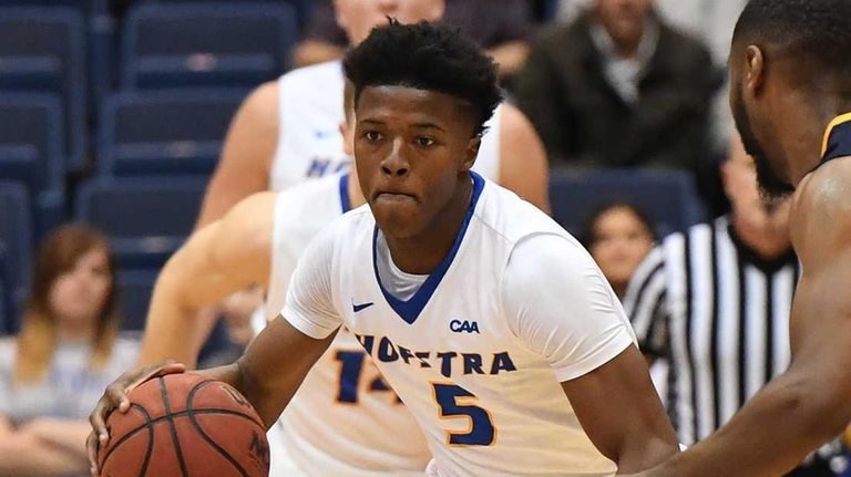 Hofstra guard Eli Pemberton drives the ball defended