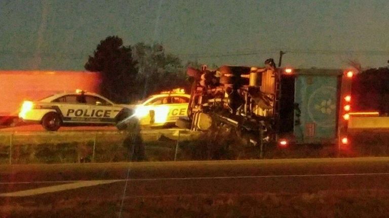 A tractor trailer lies on its side along