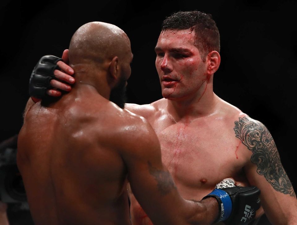Chris Weidman of the United States (right) embraces