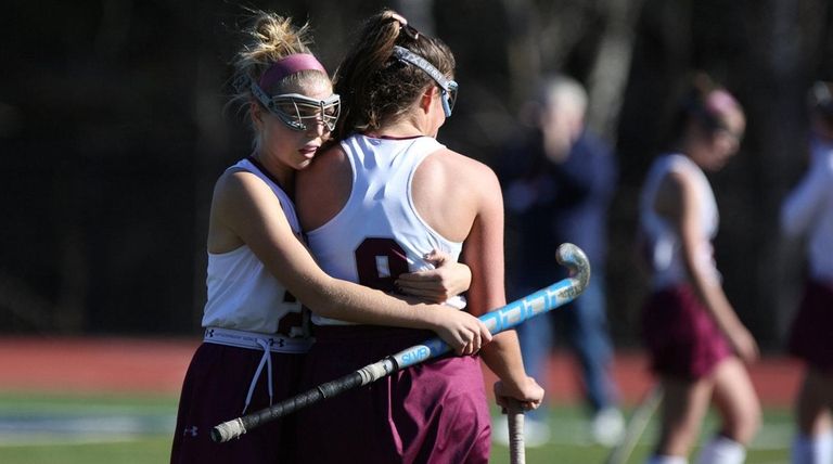 Garden City's Emily Clarke consoles teammate Devon Heaney