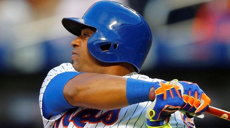 Yoenis Cespedes of the Mets follows through on