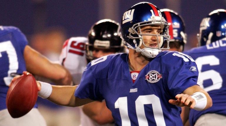 Eli Manning throws a pass in the first