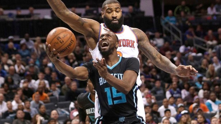 Charlotte Hornets' Kemba Walker drives past Knicks' Kyle