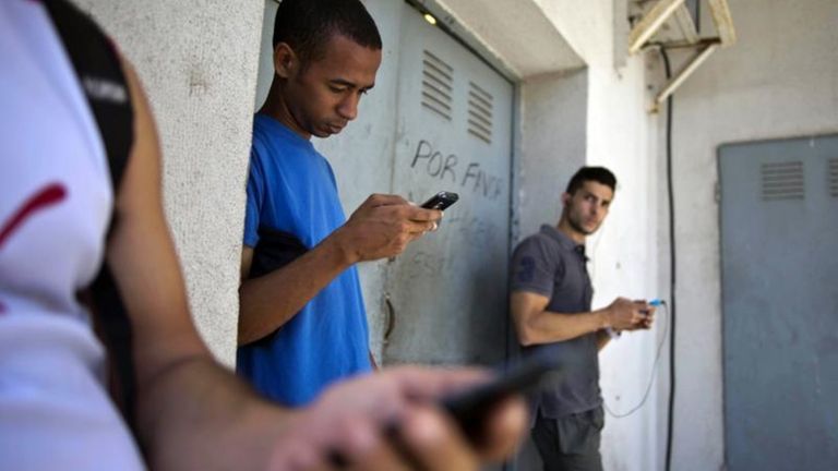 Students gather behind a business looking for a
