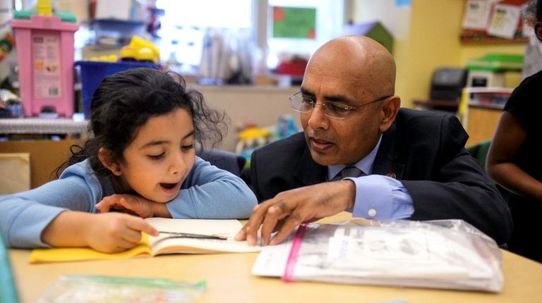 Freeport school Superintendent Kishore Kuncham works with Dayana