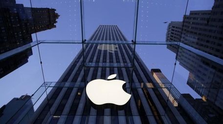 The Apple logo hangs in the glass box