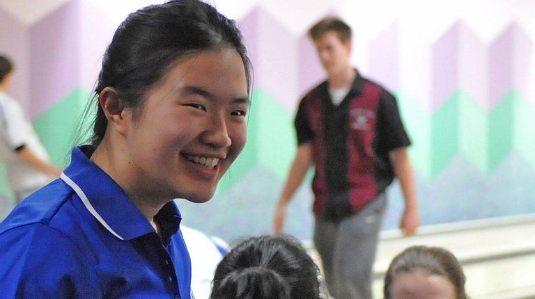 Joyce Lin of Port Washington reacts after bowling