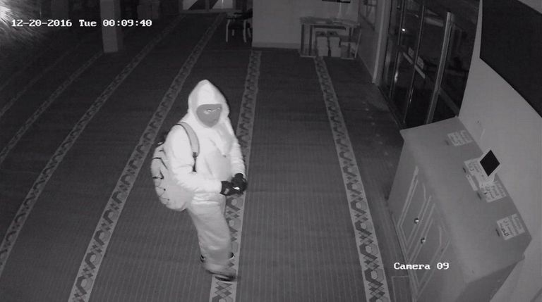 A surveillance photo shows a masked man Suffolk