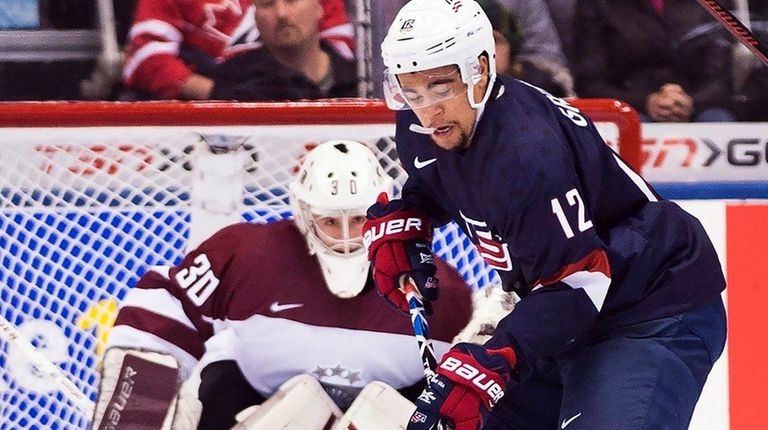 United States' Jordan Greenway (12) eyes the puck