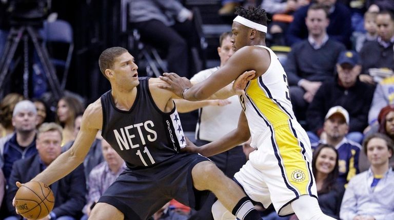 Nets center Brook Lopez holds off Pacers center