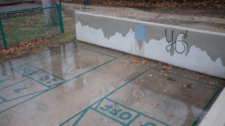 A gray box, recently painted, covers where swastikas