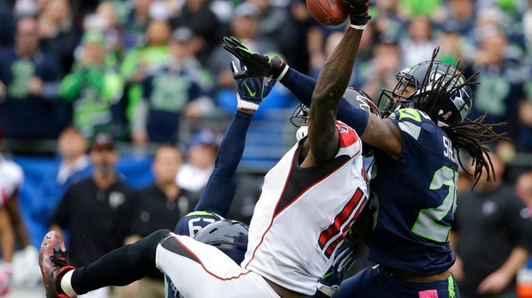 Seattle Seahawks cornerback Richard Sherman breaks up a
