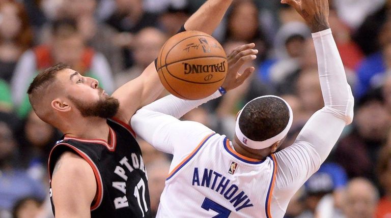 Toronto Raptors center Jonas Valanciunas (17), left, fouls
