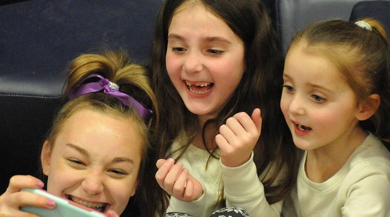 Matison Kindelmann, 6, center, and sister Charlotte Kindelmann,