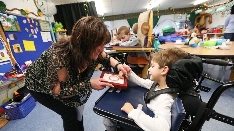 Special education teacher Cathy Faithfull works with Julian