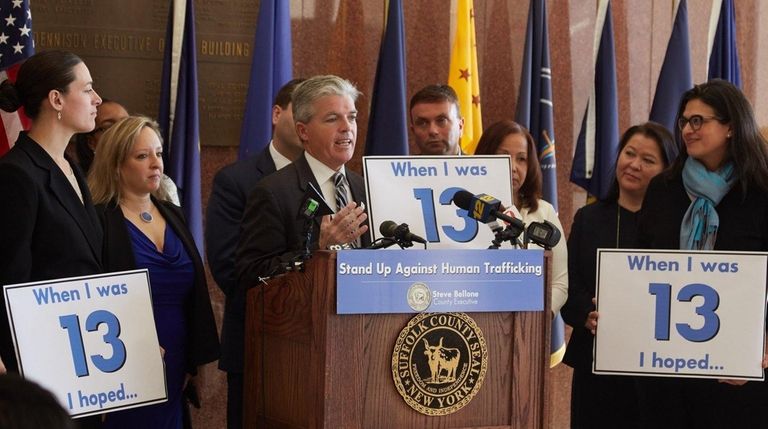 Suffolk County Executive Steve Bellone, center, announced an