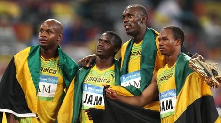 From left, Jamaica's Asafa Powell, Nesta Carter, Usain