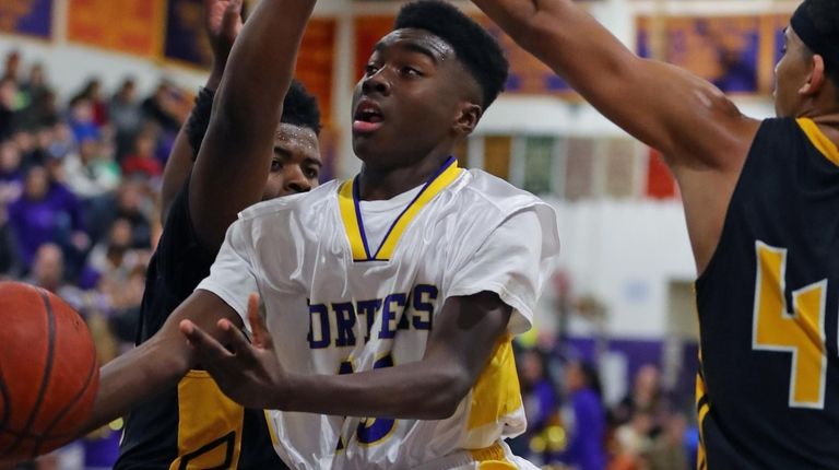 Greenport's Ahkee Anderson #13 splits the defense and
