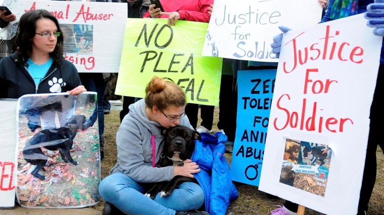 Rescue community members protest in front of the