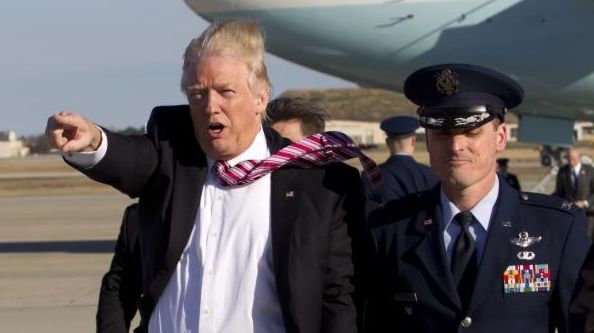 President Donald Trump walks on the tarmac as