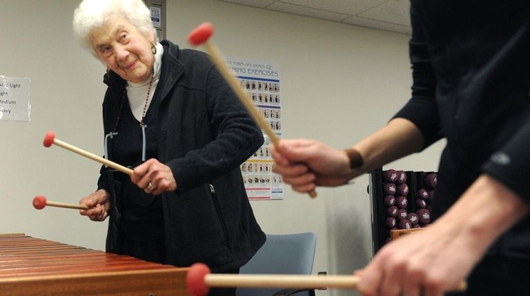 Sally Newman, 87, plays the marimba during a