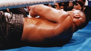 Referee Octavio Mayron counts as champion Mike Tyson