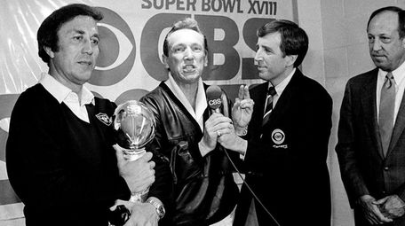 Oakland Raiders coach Tom Flores clutches the