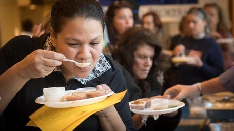 Port Washington resident Erica Pinango, left, sampling the