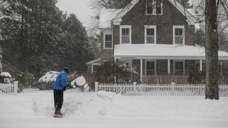Larry Hillel, of East Hampton, shovels snow in