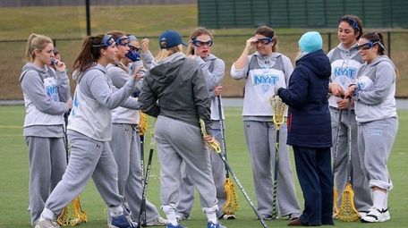 NYIT women's lacrosse players huddle during a practice