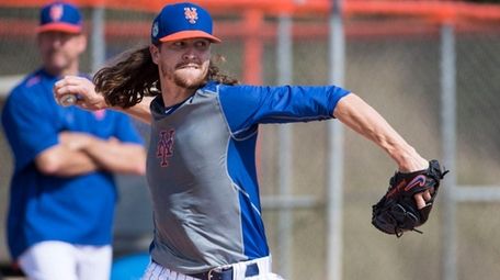 Mets pitcher Jacob deGrom throws during a spring