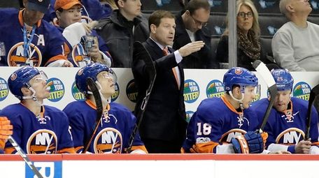 Islanders head coach Doug Weight looks on from