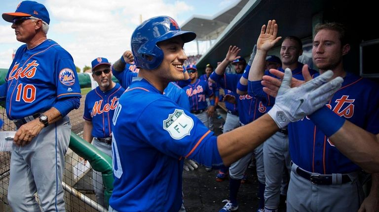 New York Mets outfielder Michael Conforto, center, high-fives