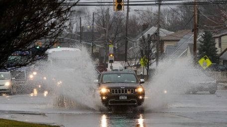 A car splashes through a puddle along the