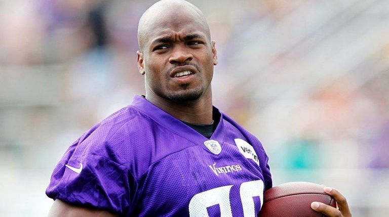 Minnesota Vikings running back Adrian Peterson runs with