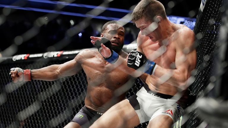 Tyron Woodley, left, takes a swing at Stephen