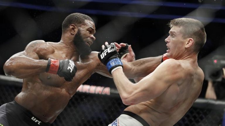 Tyron Woodley, left, hits Stephen Thompson in a