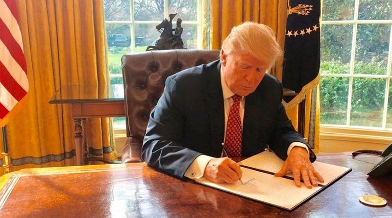 President Donald Trump signs a new executive order