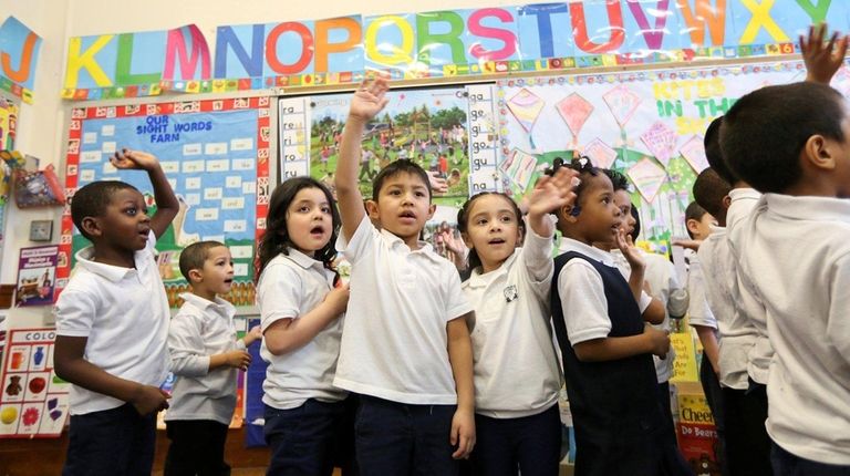 Students in a pre-K class sing a song