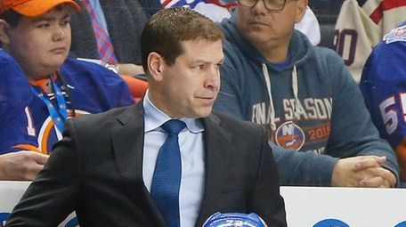 Islanders head coach Doug Weight looks on in