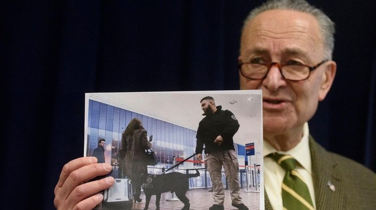 Sen. Chuck Schumer holds a photo of a
