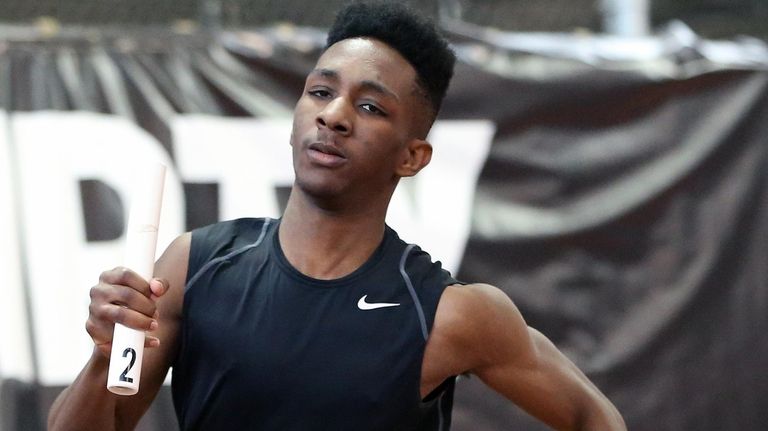 Elmont's Malik Johnson runs his leg in the
